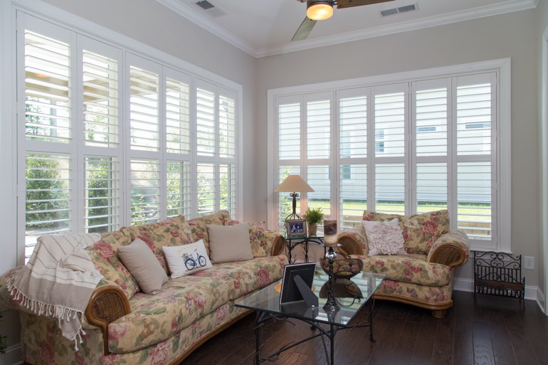 Airy sunroom with plantation shutters in Raleigh.